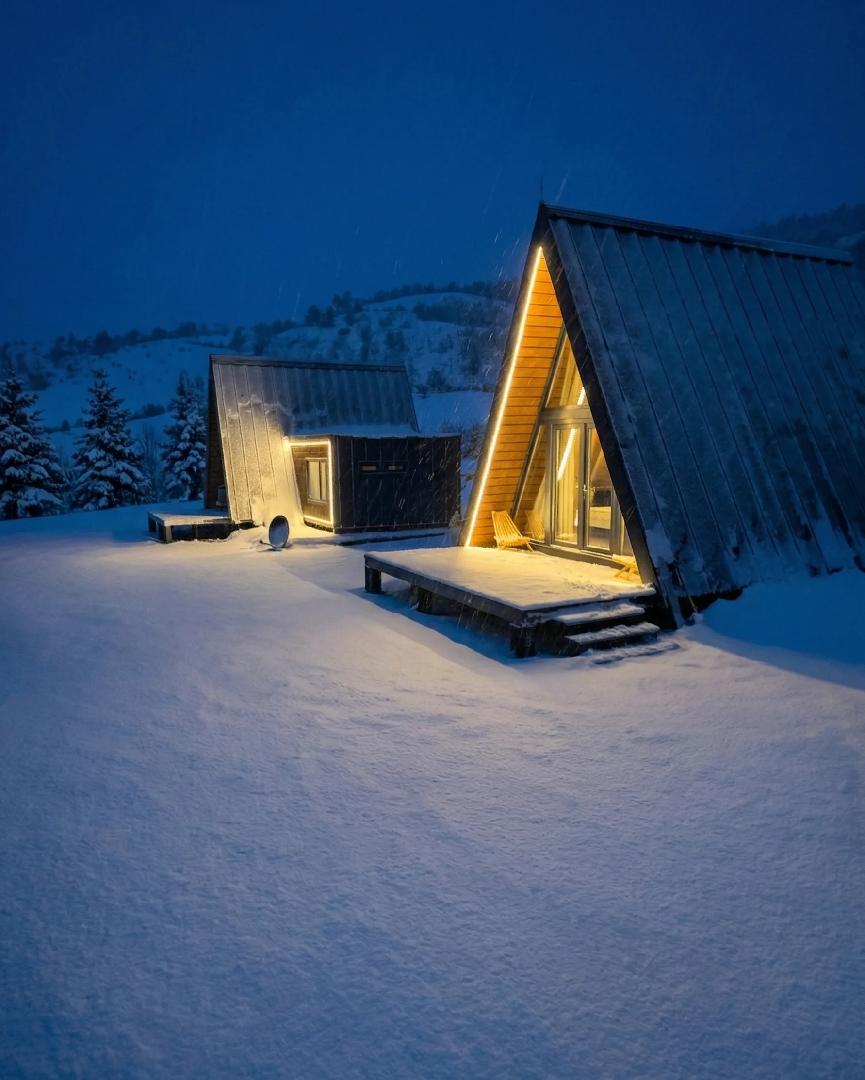 A-frame chalets at night in snow